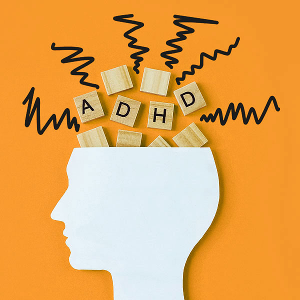 Silhouette of head with ADHD letters coming out.